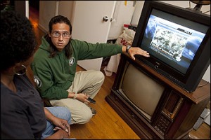 Digital TV Converter Being Attached to Analog TV